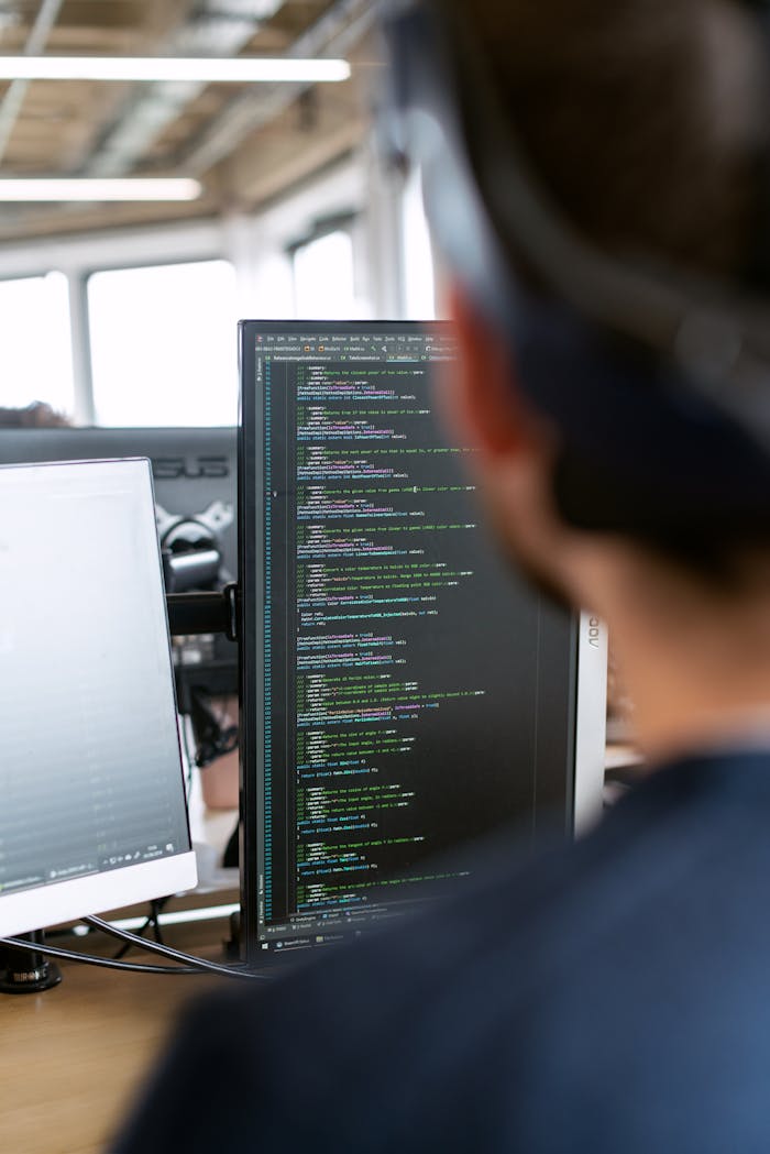 hero-img A male software engineer working on code in a modern office setting.